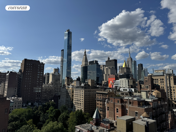 Panoramic view of a city skyline with various tall buildings and clear blue sky.