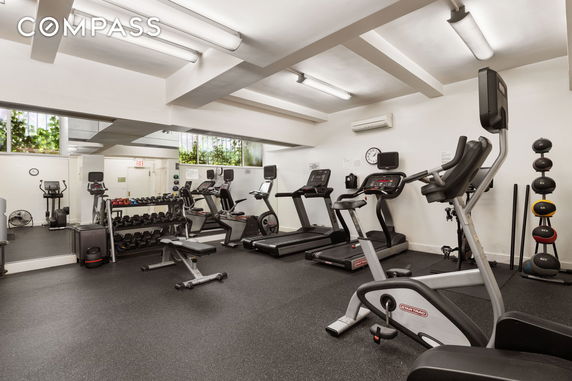Indoor gym with various exercise equipment and machines