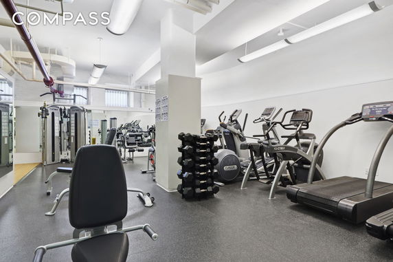 Indoor gym area with various exercise equipment.
