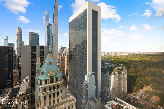 Panoramic view of city skyscrapers and park in the distance.