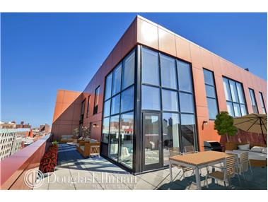 Rooftop with modern glass facade and outdoor seating areas.