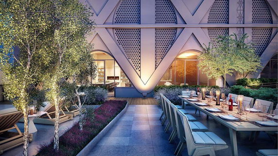 Rooftop area with dining setup and decorative plants.
