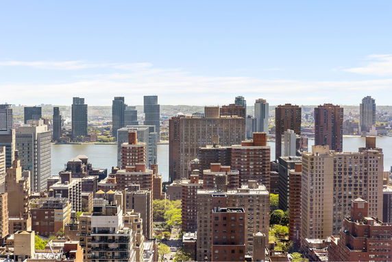 Panoramic view of multiple high-rise buildings in a city skyline.