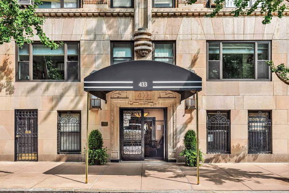 Front view of a building with a black awning.