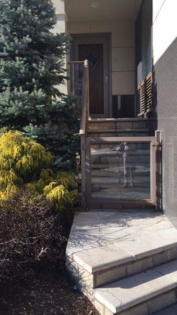 Front view of a house entrance with steps leading up to the door.