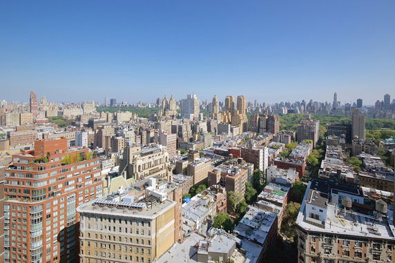 Panoramic view of a cityscape with numerous buildings and a large park area.