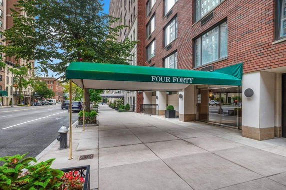 Front view of a building with a green canopy labeled 'Four Forty'.