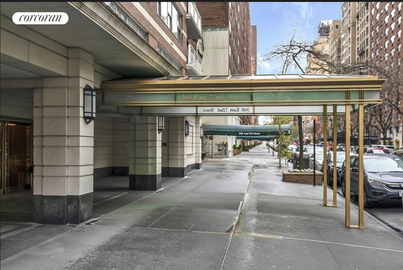 Front view of a multi-story building with an entrance canopy.