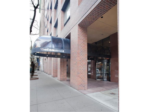 Front view of a building with a brick facade and an entrance canopy.
