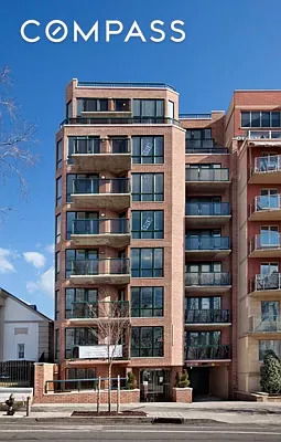 Front view of a multi-story residential building with balconies.