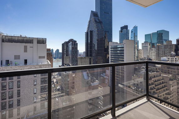 Panoramic view of city skyscrapers and buildings from a balcony.