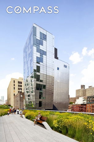 Front view of a modern, multi-story building with a glass exterior.