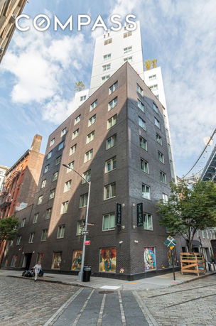 Front and side view of a multi-story apartment building with a modern design.