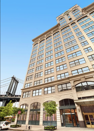 Front view of a multi-story building with numerous windows and decorative architectural elements.