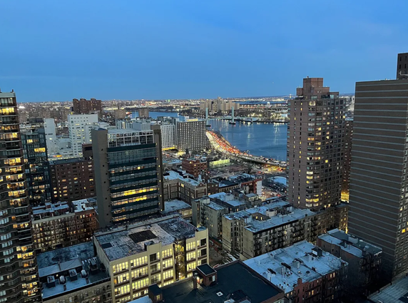 Wide angle view of cityscape with buildings and river.