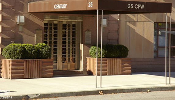 Entrance of a building with canopy and planters.