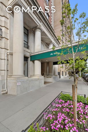 Front view of a multi-story building with classical architecture and columns.