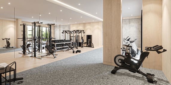 Indoor gym area with various exercise equipment and machines.