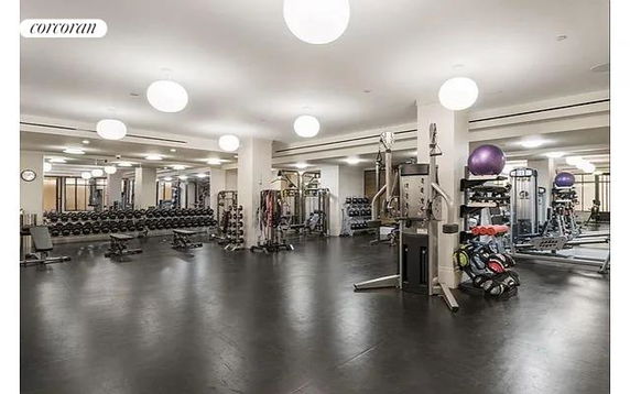 Indoor gym area with various exercise equipment and weights
