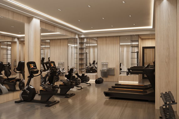 Interior view of a gym with exercise equipment and mirrors.