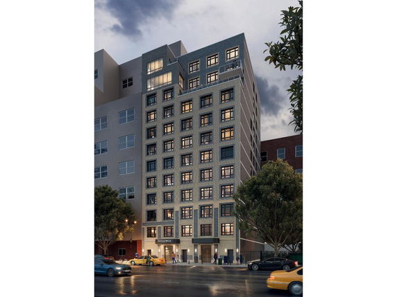 Front view of a multi-story building with numerous windows and a modern facade.