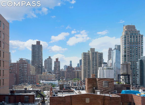View of surrounding cityscape with multiple high-rise buildings.