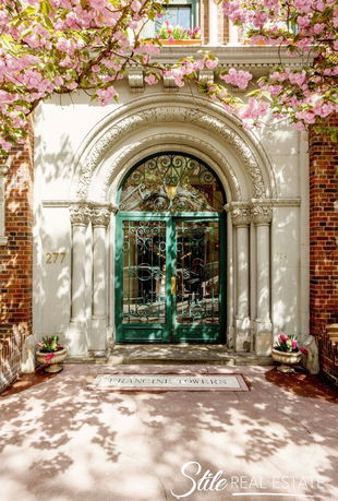Front view of a building entrance with an ornate arched doorway.