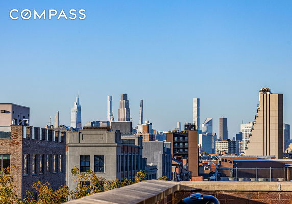 Panoramic view of a city skyline with various tall buildings and blue sky.