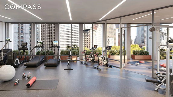 Indoor gym area with exercise equipment such as treadmills and stationary bikes.