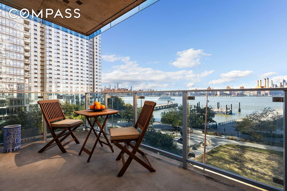 View from a balcony overlooking a river and cityscape.
