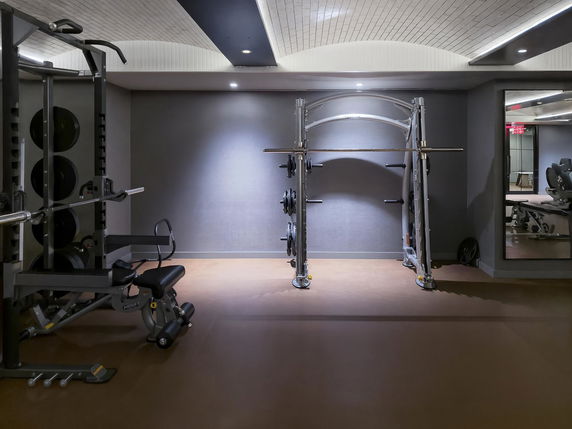 Indoor gym area with weightlifting equipment.