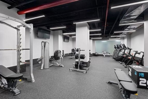 Interior view of a gym area with exercise equipment.