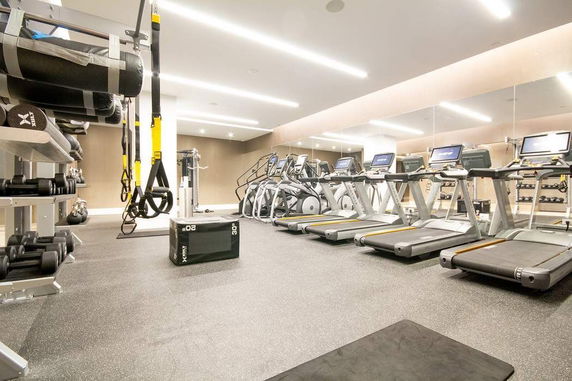 Indoor gym area with treadmills, weights, and exercise equipment.