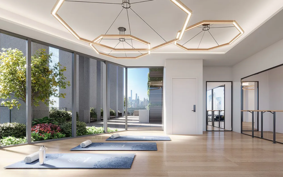 Interior view of a yoga or fitness room with mats and large windows.