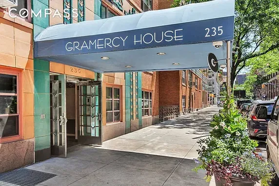Front view of a building entrance with a blue awning labeled Gramercy House.