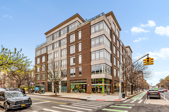 Front view of a multi-story building on a street corner.