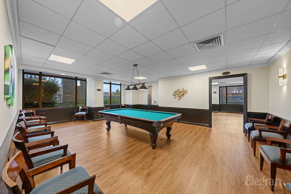 Indoor recreational area with a pool table and seating.