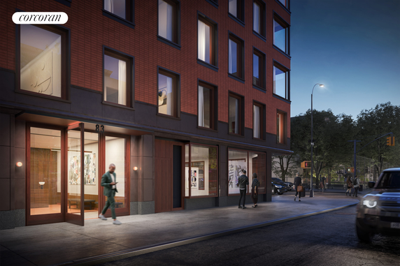 Front view of a multi-story brick building with large windows and a glass entrance.