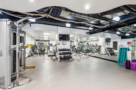 Indoor gym area with various exercise equipment.