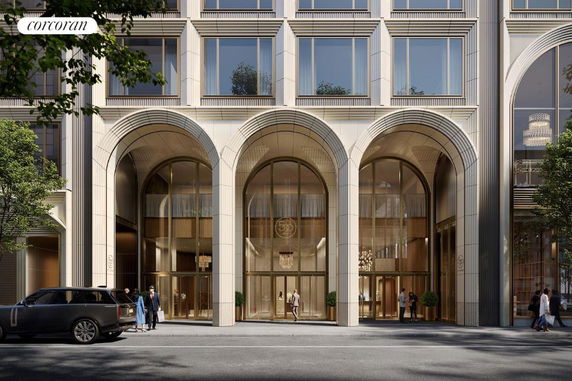 Front view of a modern multi-story building with large arched windows and entrance.