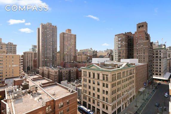 Panoramic view of city buildings and rooftops with a clear sky.