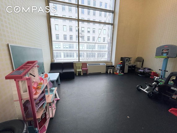 Room with toys and play equipment for children.
