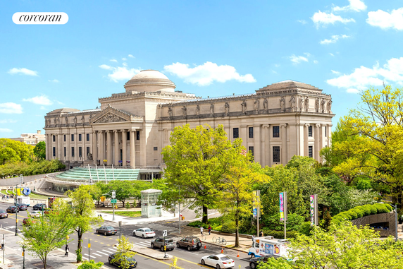 Front view of a large classical building with columns and a dome.