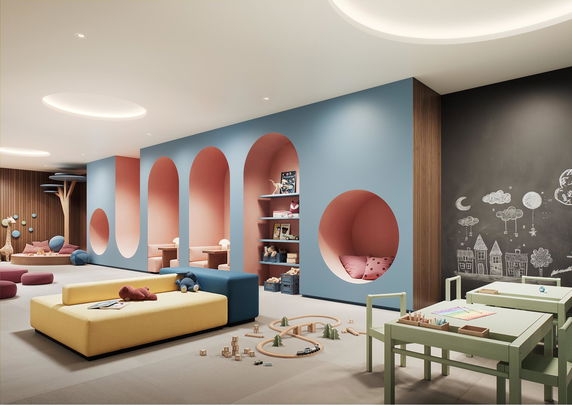 Colorful indoor play area with seating, toys, and a chalkboard wall.