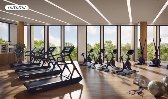 Interior view of a gym with treadmills, exercise bikes, and fitness equipment.
