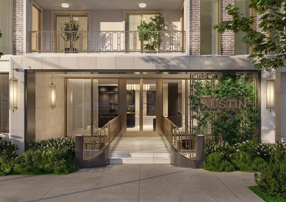 Front view of a multi-story building with entrance and decorative plants.