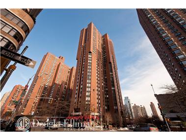 Front view of a tall apartment building with multiple stories.