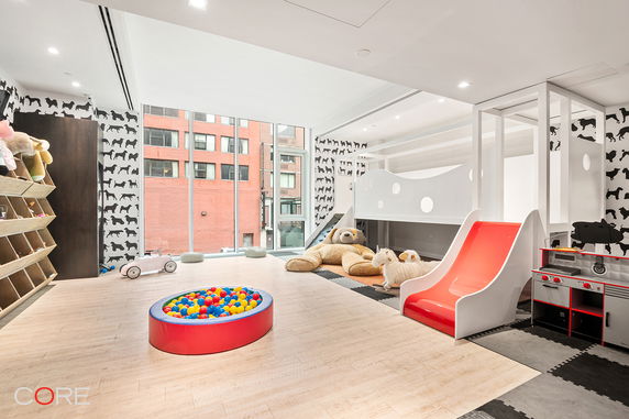 Indoor children's play area with toys, slide, and ball pit.