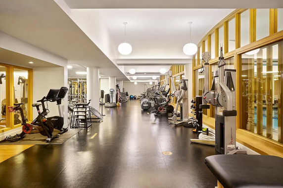 Interior view of a gym with various exercise equipment and machines.
