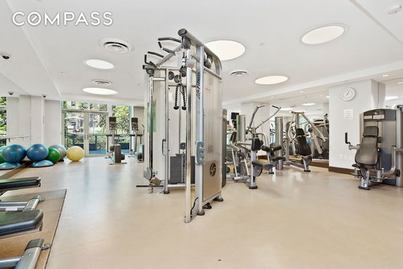 Indoor gym facility with exercise equipment and fitness balls.